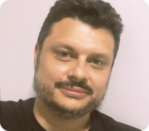 Imagem do Rodrigo Martins, CFO da Beyoung. Ele é um homem de cabelos escuros, com barba e bigode, olhando para a camera.